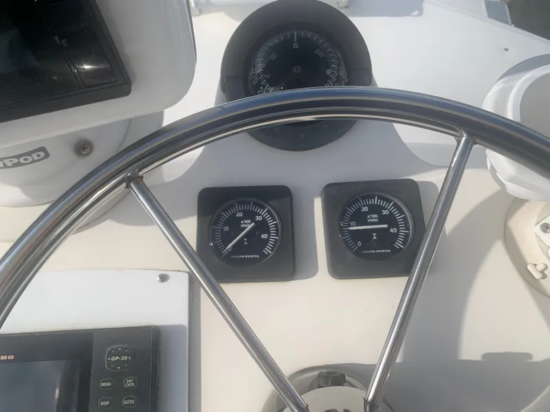 Slide: The Image of Helm console of a 2003 Carolina Classic Express boat. - 12