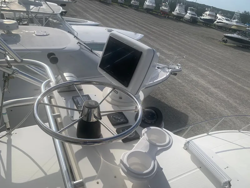 Slide: The Image of Helm of a 2003 Carolina Classic Express boat in the marina. - 15