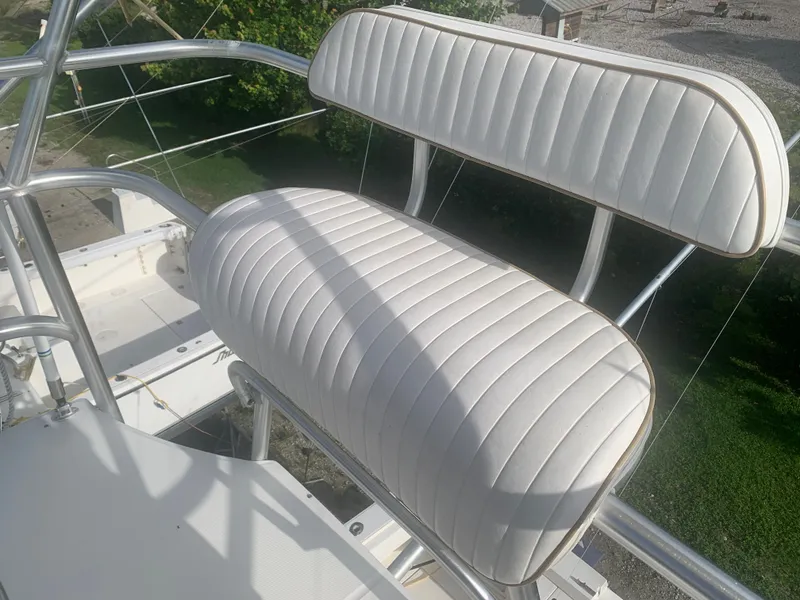 Slide: The Image of 2003 Carolina Classic Express boat seat with white upholstery. - 16