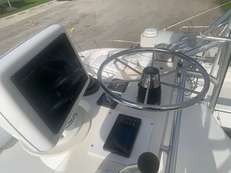 Slide: The Image of Helm of a 2003 Carolina Classic Express boat. - 17