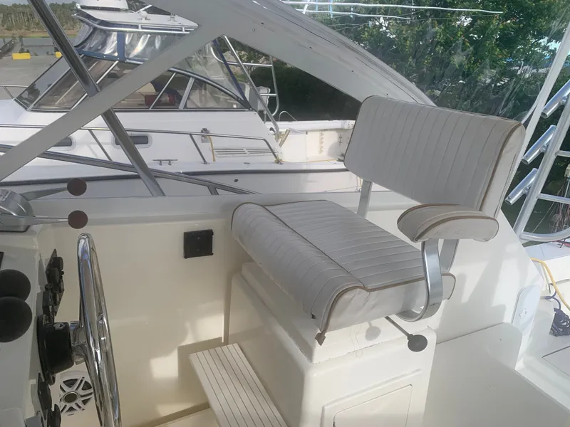 Slide: The Image of 2003 Carolina Classic Express boat helm with seating. - 23