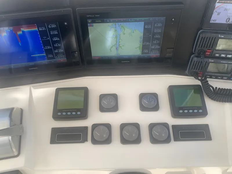 Slide: The Image of 2003 Carolina Classic Express boat console with Garmin displays. - 24