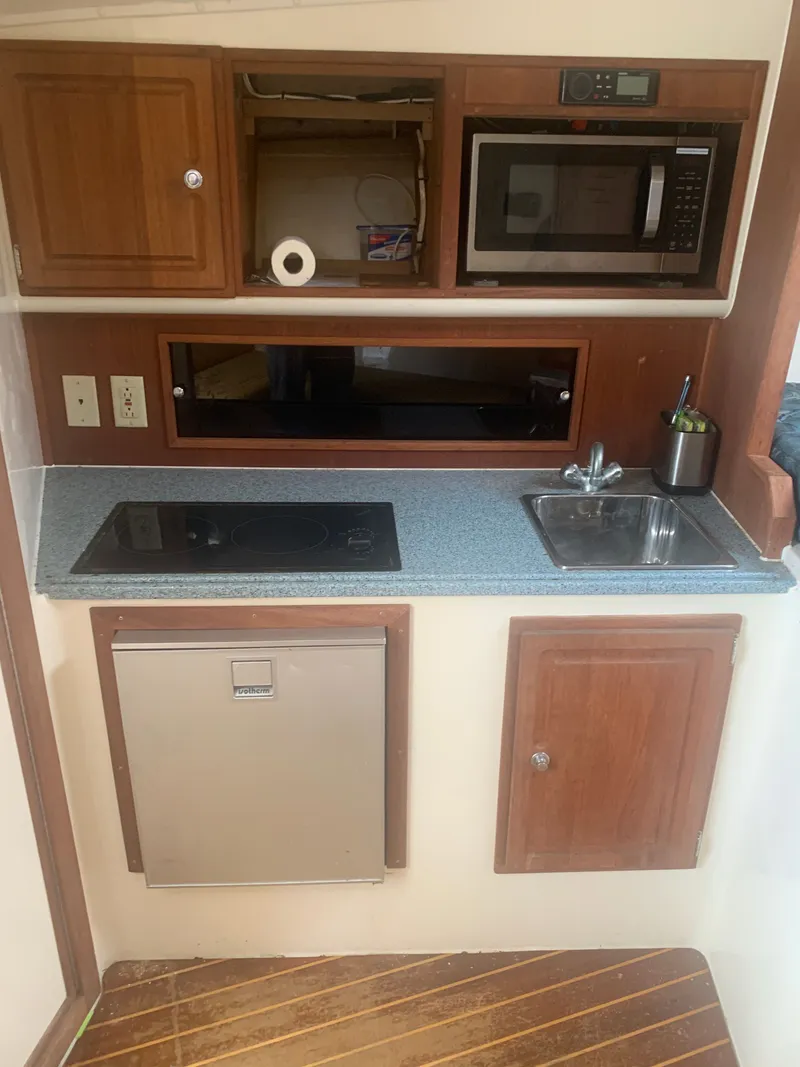 Slide: The Image of Galley kitchen in a 2003 Carolina Classic Express boat. - 3