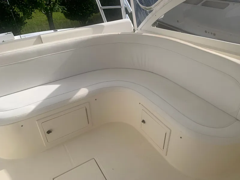 Slide: The Image of 2003 Carolina Classic Express boat with white seating area. - 31