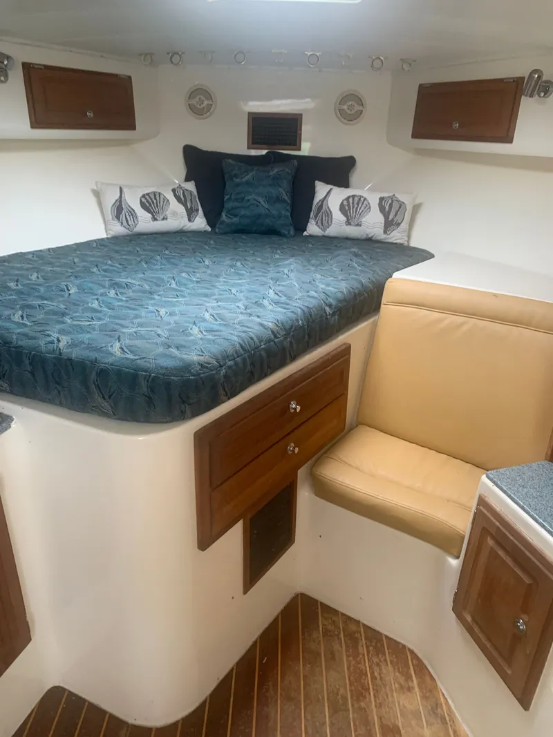 Slide: The Image of Interior of a 2003 Carolina Classic Express with bed and seating. - 34