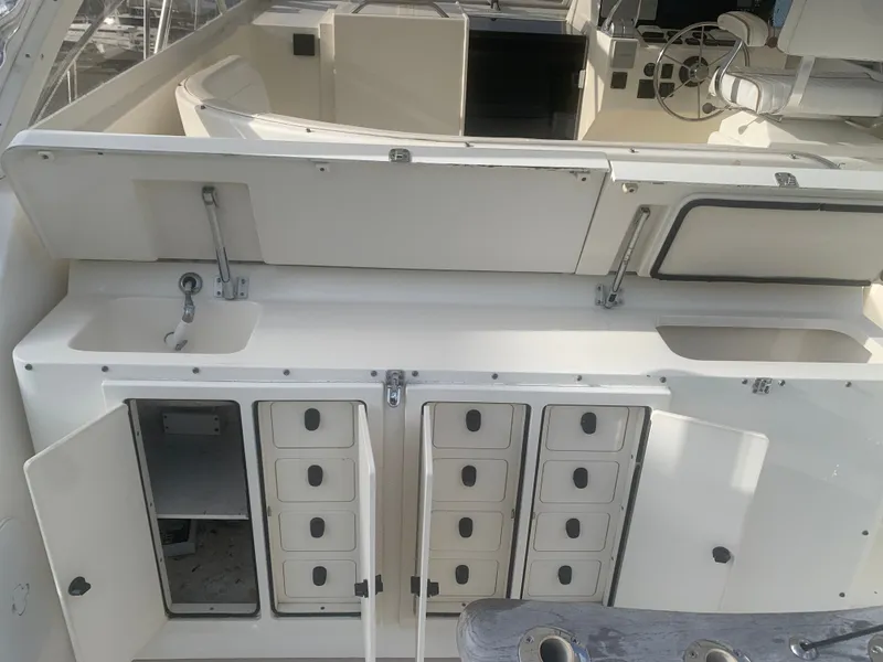 Slide: The Image of Interior of a 2003 Carolina Classic Express boat with storage compartments. - 4