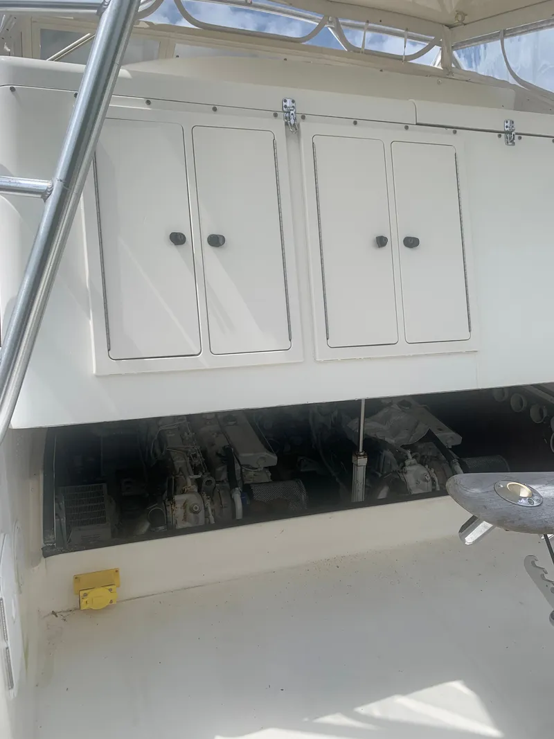 Slide: The Image of 2003 Carolina Classic Express boat engine compartment with storage. - 48