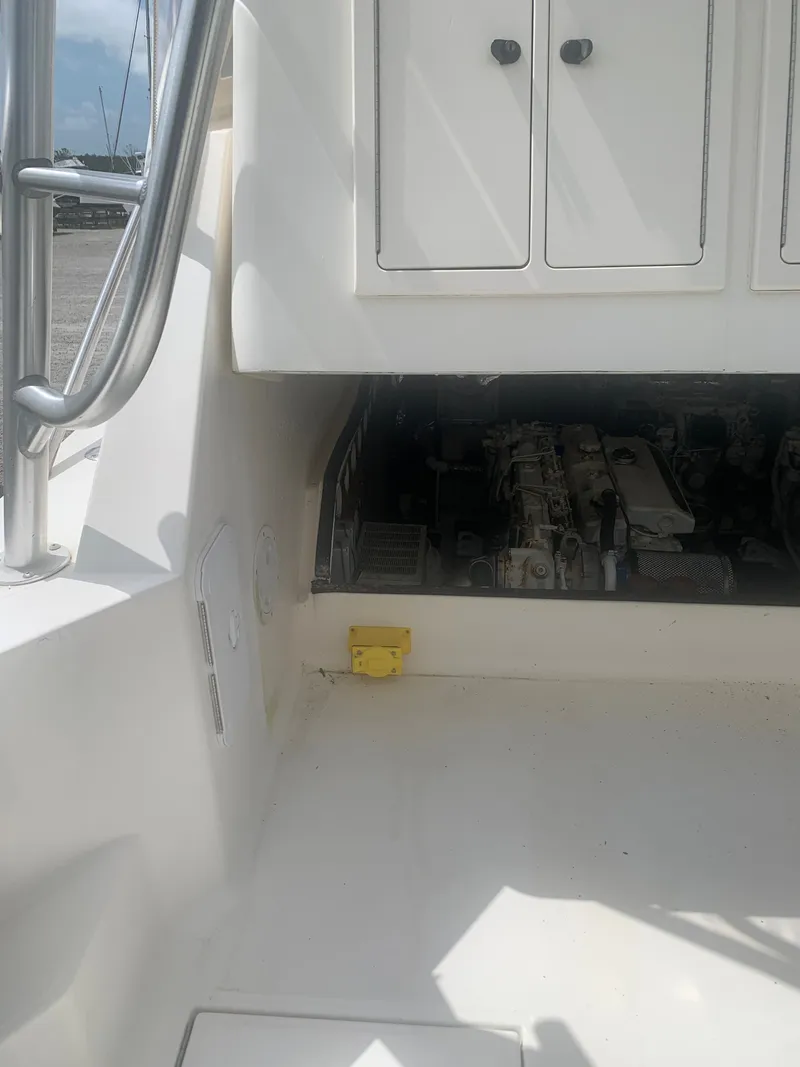 Slide: The Image of Engine compartment of a 2003 Carolina Classic Express boat. - 49