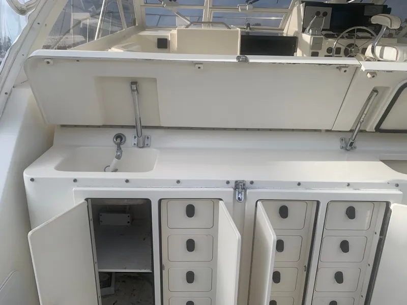 Slide: The Image of Interior of a 2003 Carolina Classic Express boat with storage compartments. - 5
