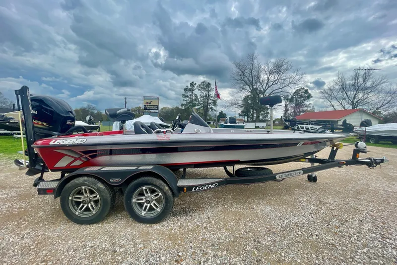 The Image of 2013 Legend Alpha 199 DCX boat on trailer under cloudy sky. - 0