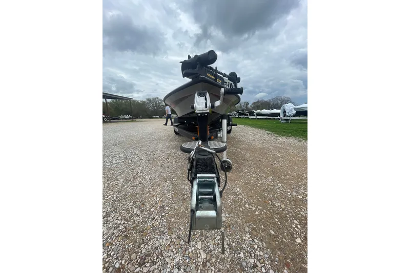 Slide: The Image of 2013 Legend Alpha 199 DCX boat on a gravel lot under cloudy skies. - 5