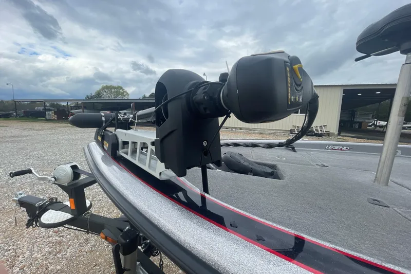 Slide: The Image of 2013 Legend Alpha 199 DCX boat with trolling motor, parked outdoors under cloudy skies. - 7