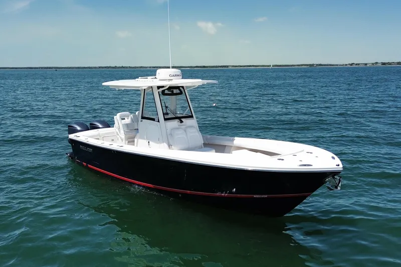 The Image of 2020 Regulator 28 boat on calm blue water under clear sky. - 0