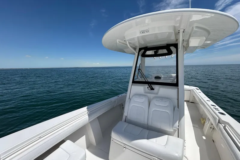 Slide: The Image of 2020 Regulator 28 boat on open sea under clear blue sky. - 7