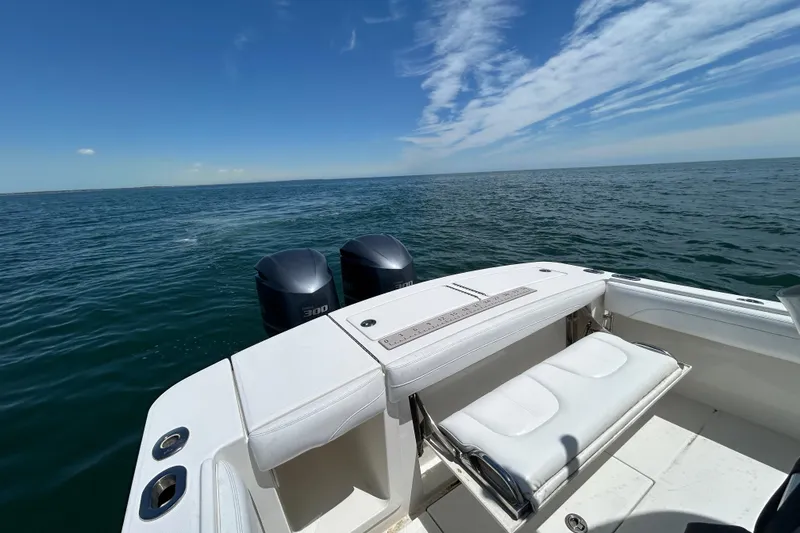 Slide: The Image of 2020 Regulator 28 boat with dual engines on open water under clear blue sky. - 9