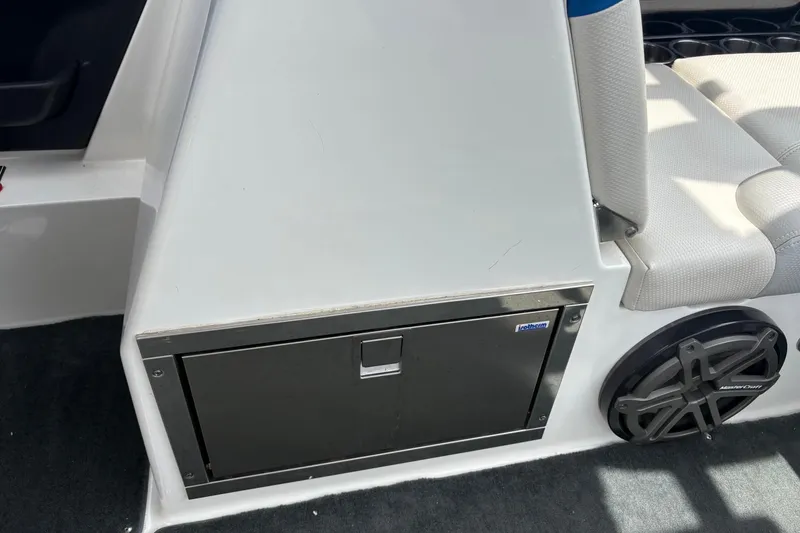 Slide: The Image of 2016 MasterCraft X26 boat interior with storage compartment and speaker. - 10