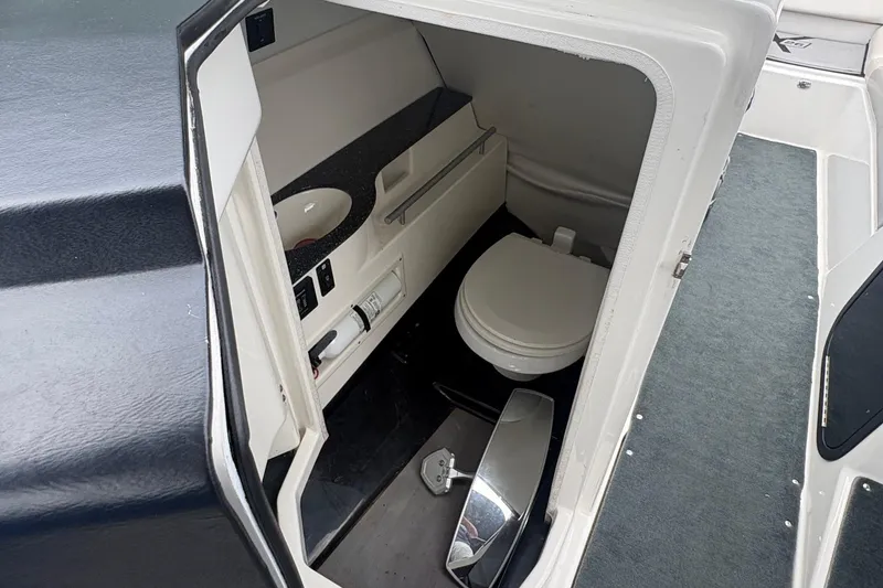 Slide: The Image of Interior view of a 2016 MasterCraft X26 boat bathroom with toilet and sink. - 9