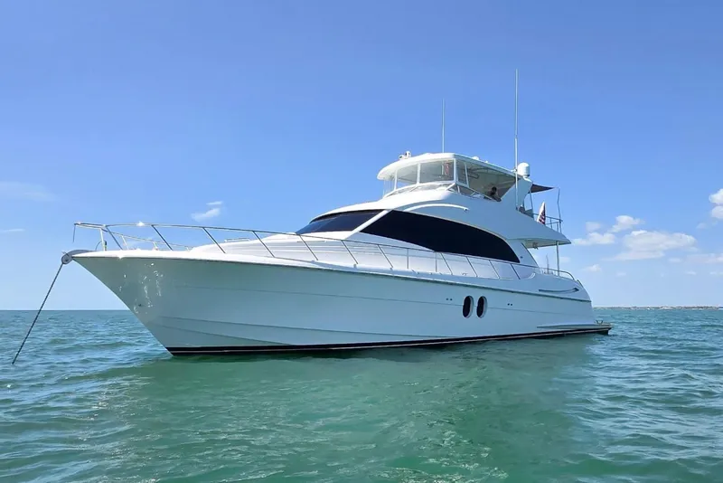 The Image of 2009 Hatteras 60 Motor Yacht on calm blue water under clear sky. - 0