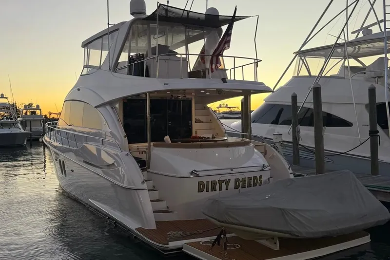 Slide: The Image of 2009 Hatteras 60 Motor Yacht docked at sunset with covered tender. - 10