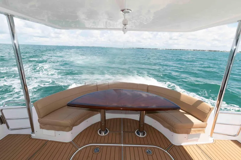 Slide: The Image of Aft deck of 2009 Hatteras 60 Motor Yacht with ocean view and seating area. - 13