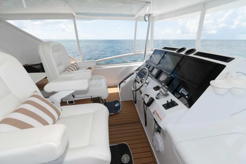 Slide: The Image of Helm of 2009 Hatteras 60 Motor Yacht with ocean view and modern controls. - 19