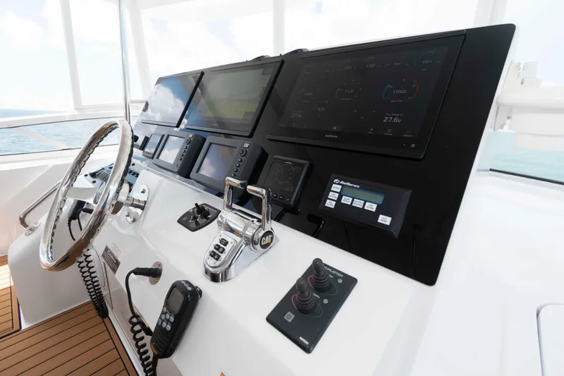 Slide: The Image of Helm of 2009 Hatteras 60 Motor Yacht with advanced navigation controls and displays. - 20