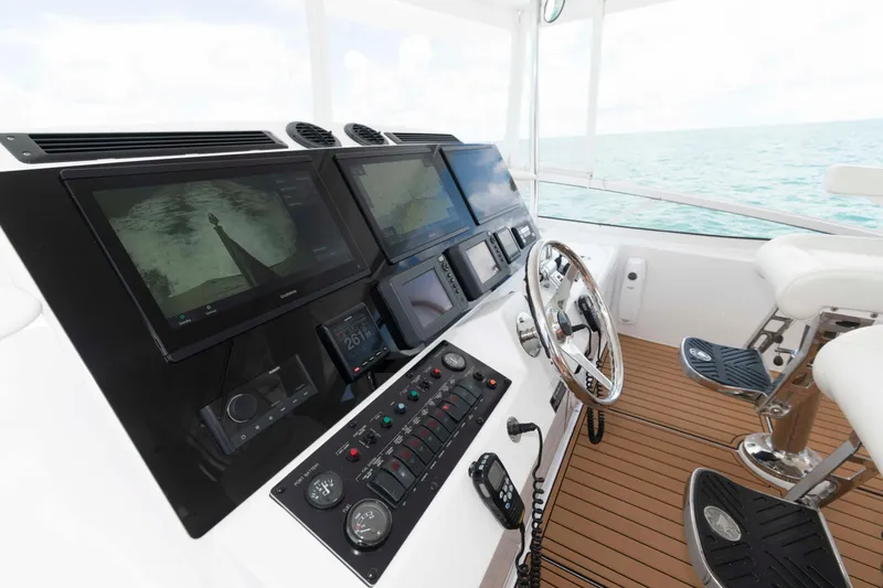 Slide: The Image of Helm of 2009 Hatteras 60 Motor Yacht with modern navigation displays and controls. - 23