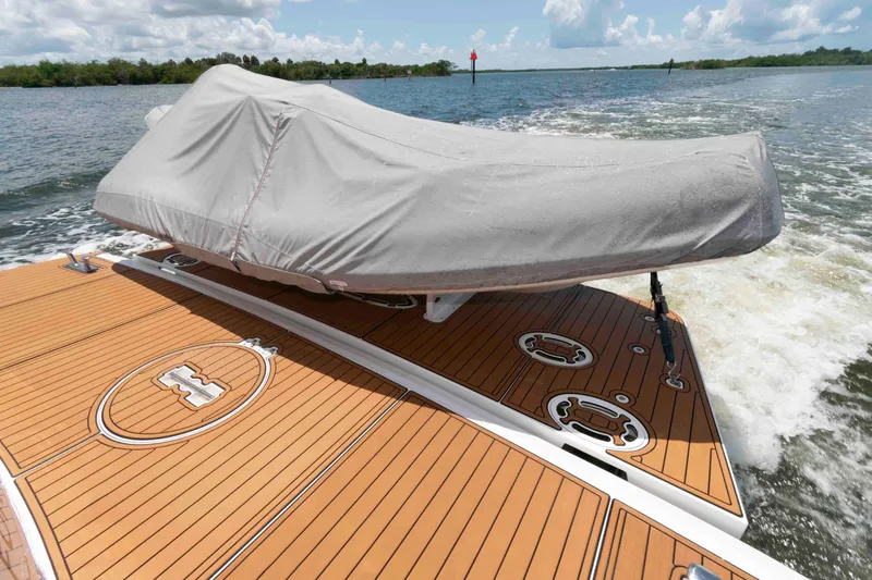 Slide: The Image of 2009 Hatteras 60 Motor Yacht deck with covered equipment, cruising on open water. - 29