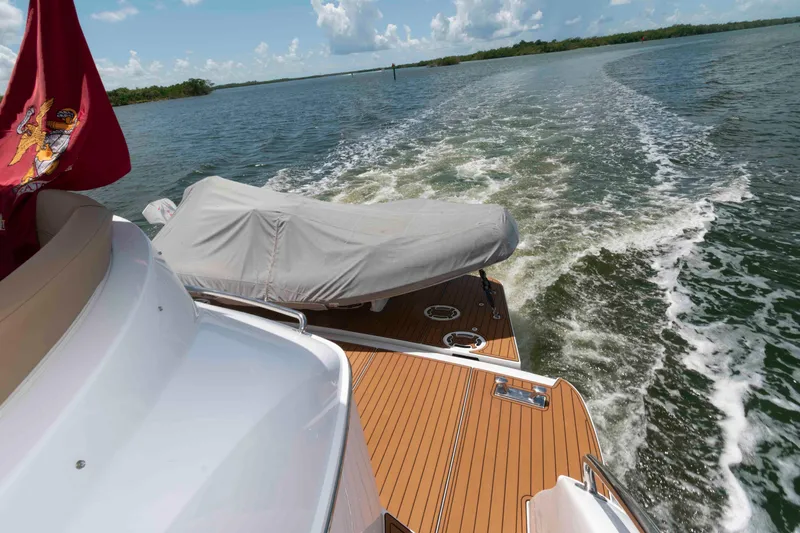 Slide: The Image of 2009 Hatteras 60 Motor Yacht cruising on open water, rear deck view. - 31
