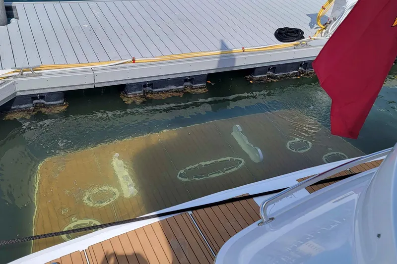 Slide: The Image of 2009 Hatteras 60 Motor Yacht docked, with underwater view of propellers and rudders. - 32