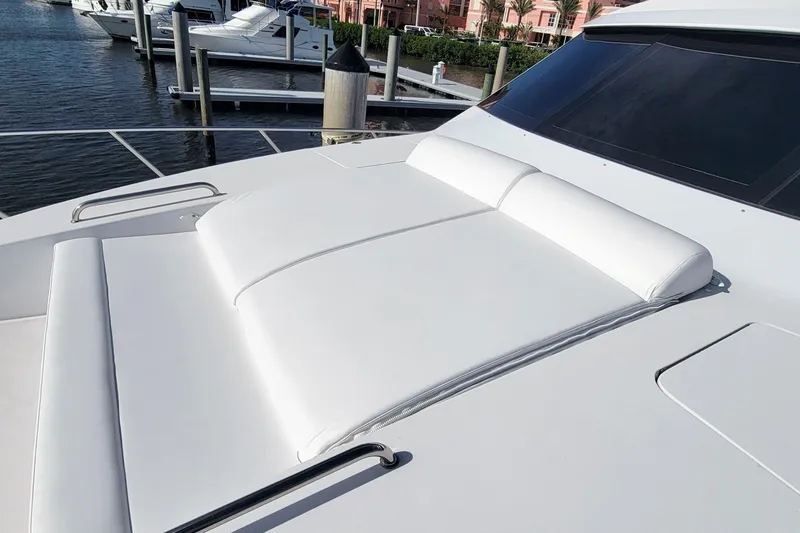 Slide: The Image of 2009 Hatteras 60 Motor Yacht sun deck with white cushions at marina. - 36