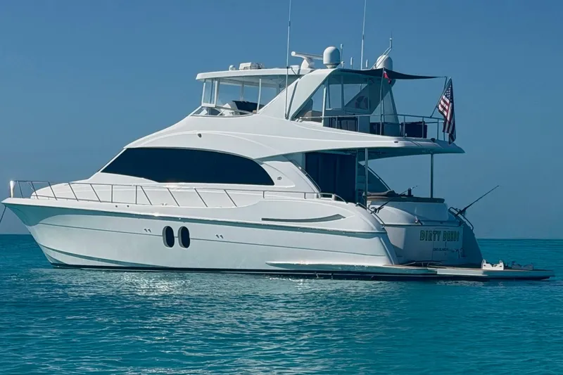 Slide: The Image of 2009 Hatteras 60 Motor Yacht on clear blue water, side view. - 4