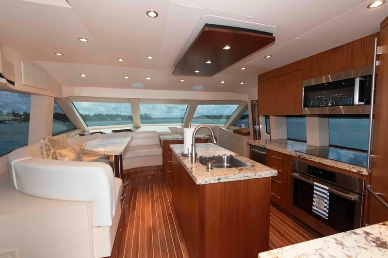 Slide: The Image of Luxurious interior of 2009 Hatteras 60 Motor Yacht with modern kitchen and seating area. - 46