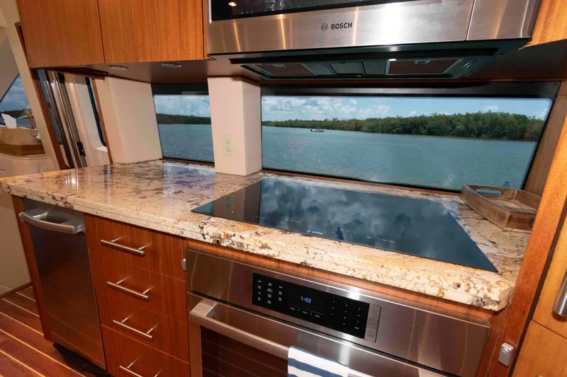 Slide: The Image of Luxurious kitchen interior of 2009 Hatteras 60 Motor Yacht with scenic water view. - 48