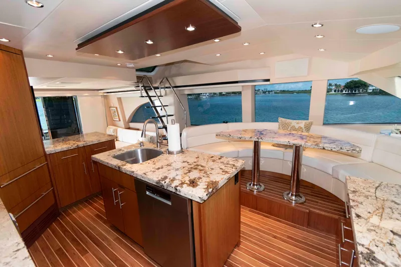Slide: The Image of Luxurious interior of 2009 Hatteras 60 Motor Yacht with elegant dining area and modern kitchen. - 49