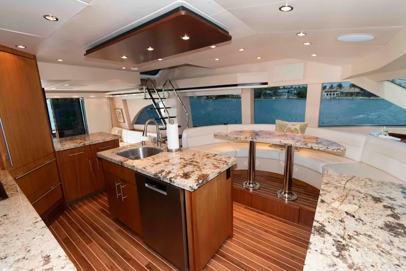 Slide: The Image of Luxurious interior of 2009 Hatteras 60 Motor Yacht with modern kitchen and seating area. - 52