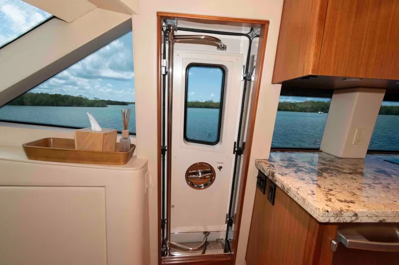 Slide: The Image of Interior of 2009 Hatteras 60 Motor Yacht with scenic water view through window. - 56