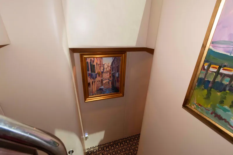 Slide: The Image of Interior of 2009 Hatteras 60 Motor Yacht with framed artwork on walls. - 58