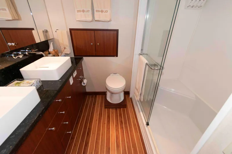 Slide: The Image of Luxurious bathroom in 2009 Hatteras 60 Motor Yacht with modern fixtures and wooden flooring. - 64