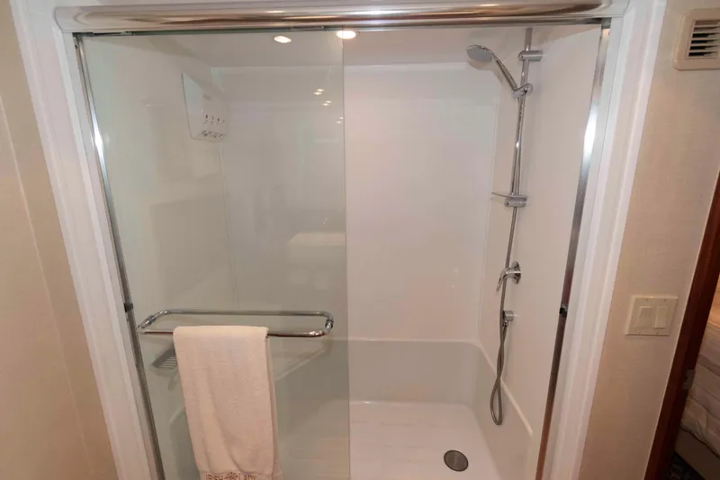 Slide: The Image of Shower area in 2009 Hatteras 60 Motor Yacht with glass door and chrome fixtures. - 66