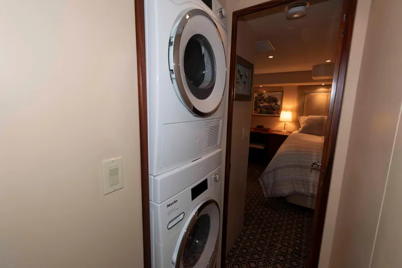 Slide: The Image of Stacked washer and dryer in 2009 Hatteras 60 Motor Yacht hallway near bedroom. - 67