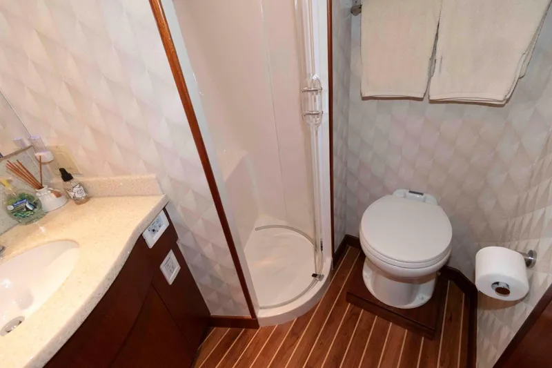 Slide: The Image of Luxurious bathroom in 2009 Hatteras 60 Motor Yacht with shower, toilet, and vanity. - 73