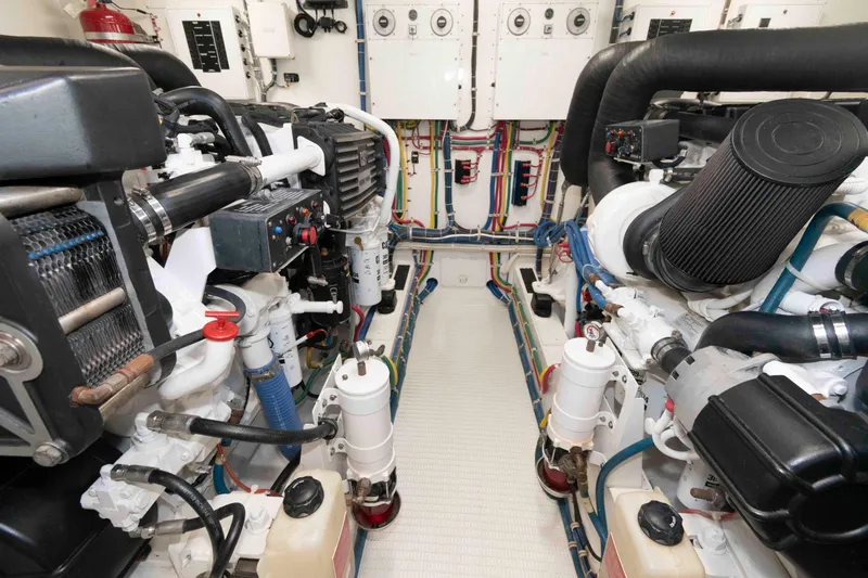Slide: The Image of Engine room of 2009 Hatteras 60 Motor Yacht, showcasing detailed mechanical components. - 74