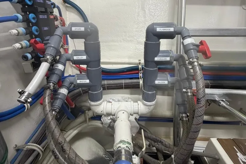 Slide: The Image of Plumbing system of a 2009 Hatteras 60 Motor Yacht with labeled pipes and valves. - 82