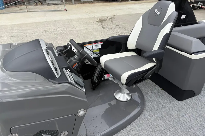 Slide: The Image of 2023 South Bay 525 RS 3.0 Arch boat interior with captain's chair and steering console. - 12