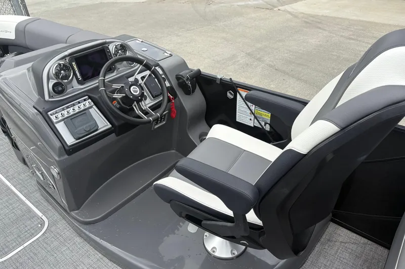 Slide: The Image of Captain's helm of 2023 South Bay 525 RS 3.0 Arch boat with steering wheel and controls. - 16