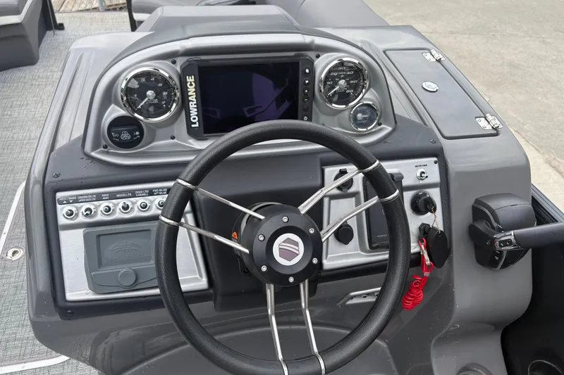 Slide: The Image of Dashboard of 2023 South Bay 525 RS 3.0 Arch boat with steering wheel and controls. - 17