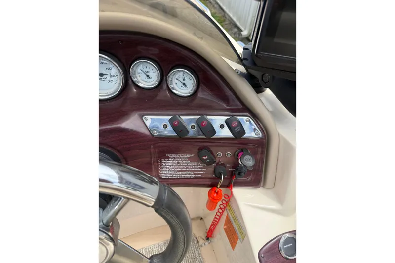Slide: The Image of Dashboard of a 2008 Sylvan 8523 Mandalay RE pontoon boat with gauges and controls. - 10