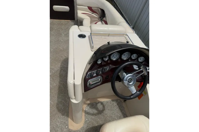Slide: The Image of 2008 Sylvan 8523 Mandalay RE boat dashboard with steering wheel and gauges. - 13