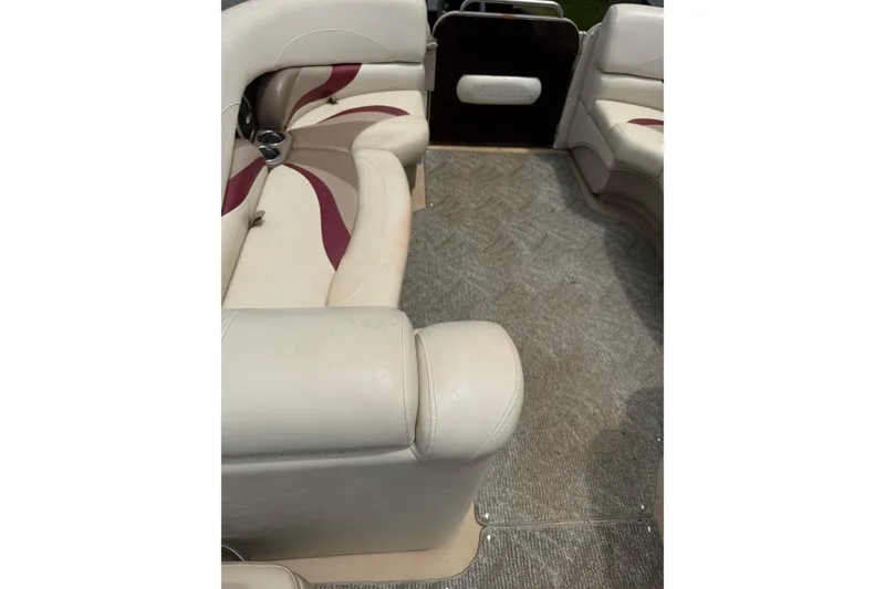 Slide: The Image of 2008 Sylvan 8523 Mandalay RE boat interior with beige and maroon seating. - 16